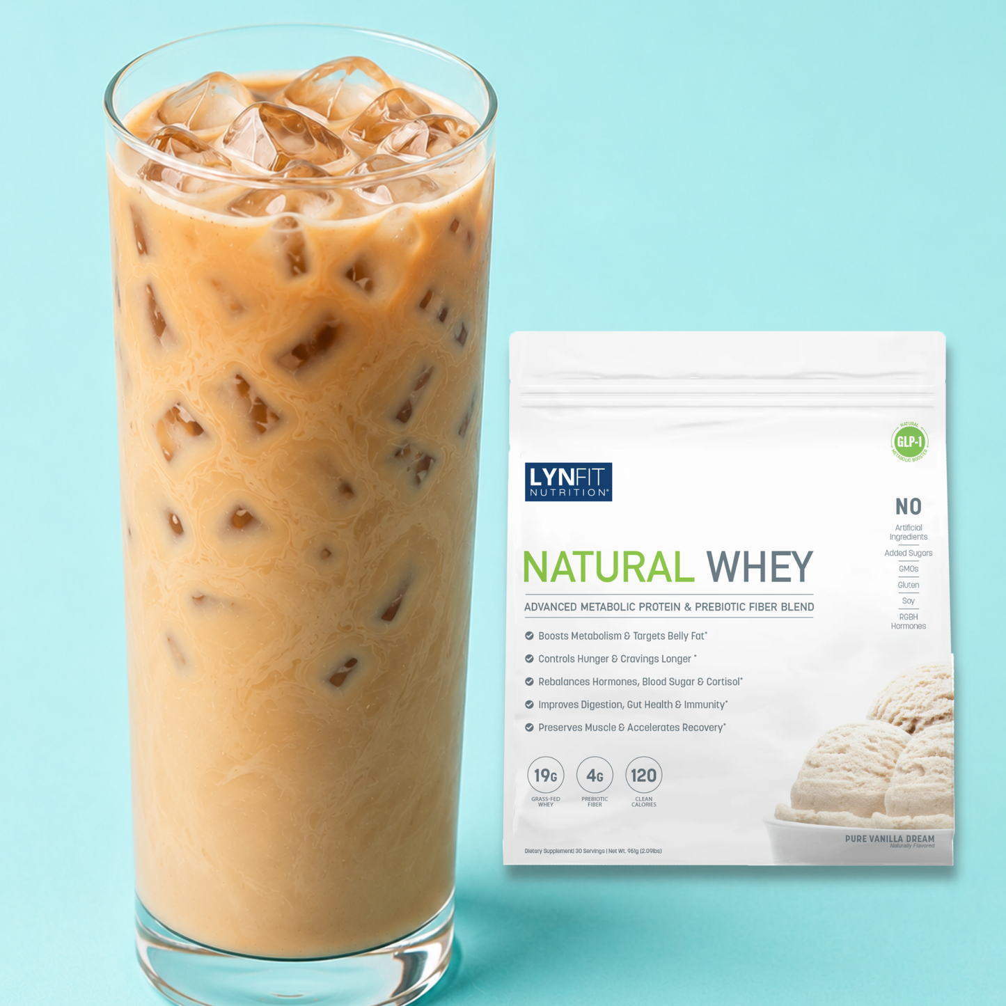 A tall glass of iced coffee with creamy brown liquid and ice cubes stands beside a white bag of Lynfit Nutritionals Natural Whey vanilla flavor, set against a light blue background.